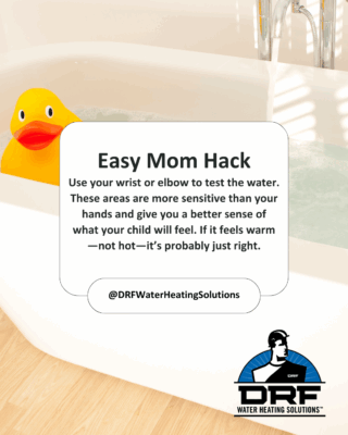 Cute bath thermometer shaped like a duck floating in bathtub water. Hot water safety.